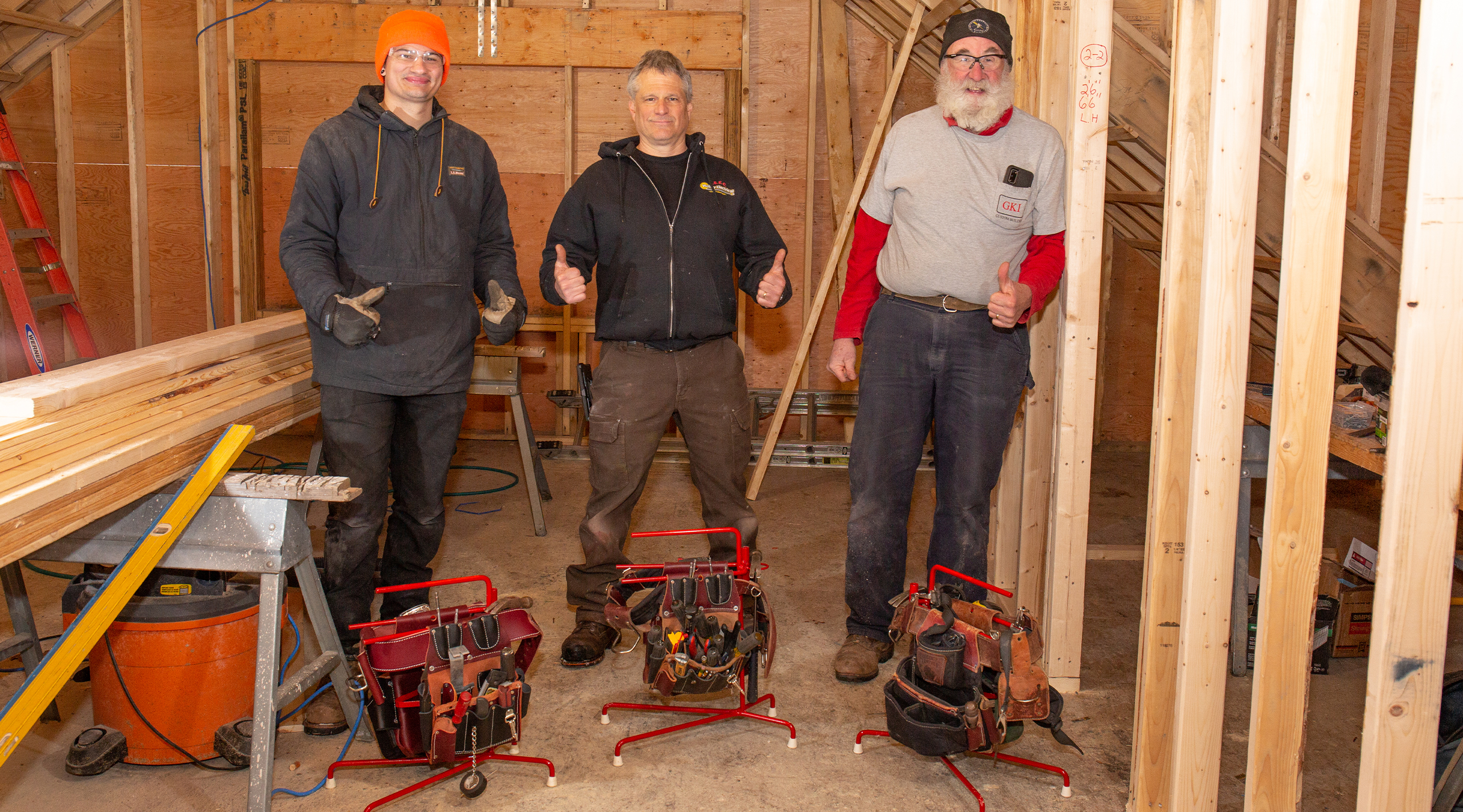 three Mantis Tool Belt Stands in use by contractors